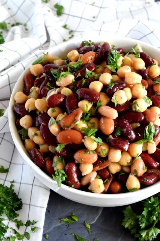 A quick, delicious, and hearty salad that's perfect for any occasion! This 5 Minute Bean and Chickpea Salad will pair well with anything you serve at a picnic, backyard barbecue, or local church potluck! A tangy and savoury salad this good and this inexpensive is a keeper for sure! #chickpea #bean #salad #side #vegetarian #nobake #canned #5minuterecipes