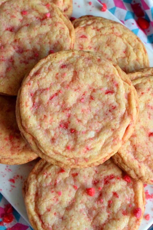 Not all great cookies are soft and chewy. Valentine Cinnamon Heart Cookies are thin and crispy with a soft, sweet center. And, they're packed full of everyone's favourite cinnamon candy! Make a batch for your special someone today! #valentine #cinnamon #heart #candy #cookies