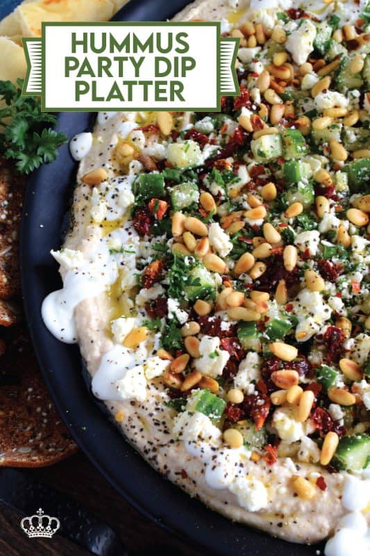 What's a party without dip? Hummus Party Dip Platter is a large, layered dip that's just perfect for entertaining a crowd. This all-in-one dip has hummus, sour cream, pine nuts, sun dried tomatoes, cucumbers, feta, and a few other ingredients too! Serve this on any occasion for a delicious, crowd-pleasing appetizer! #hummus #dip #appetizer #party #platter #spread
