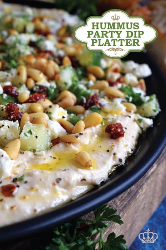 What's a party without dip? Hummus Party Dip Platter is a large, layered dip that's just perfect for entertaining a crowd. This all-in-one dip has hummus, sour cream, pine nuts, sun dried tomatoes, cucumbers, feta, and a few other ingredients too! Serve this on any occasion for a delicious, crowd-pleasing appetizer! #hummus #dip #appetizer #party #platter #spread