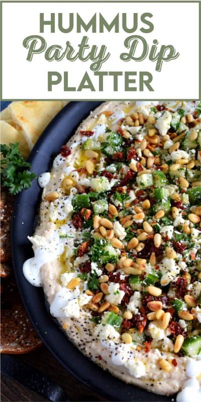 What's a party without dip? Hummus Party Dip Platter is a large, layered dip that's just perfect for entertaining a crowd. This all-in-one dip has hummus, sour cream, pine nuts, sun dried tomatoes, cucumbers, feta, and a few other ingredients too! Serve this on any occasion for a delicious, crowd-pleasing appetizer! #hummus #dip #appetizer #party #platter #spread