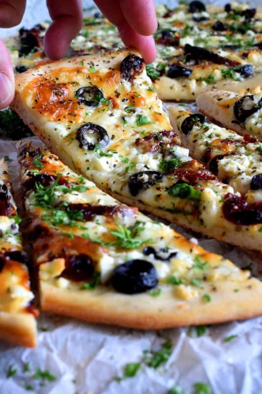 Fast, easy, and delicious Homemade Mediterranean Flatbread-style pizza in less than thirty minutes! Simply change the toppings to suit your preferences! #flatbread #pizza #Mediterranean #homemade #recipe