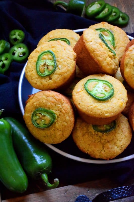 Super light and fluffly, these extremely delicious Jalapeno Corn Muffins are the perfect accompaniment to soups and chilies.  Prepared with whole corn kernals, cornmeal, buttermilk, and butter, what's not to love?  Spicy and savoury, these muffins are absolutely marvelous when served warm with a drizzle of honey! #cornmuffins #jalapeno #cornmeal #cornbread