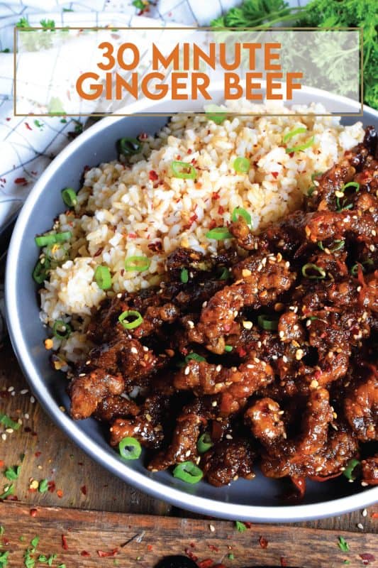 Thinly sliced beef, fried until crispy, and coated in a sweet and slightly spicy garlic and ginger sauce; 30 Minute Ginger Beef is an inexpensive dinner the whole family will love! #ginger #beef #takeout #homemade #garlic #fried #crispy
