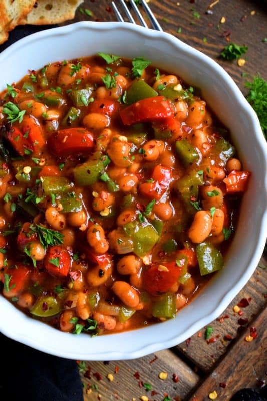 With the help of some fresh vegetables and a few herbs and spices from your pantry or spice rack, this Dressed Up Canned Beans in Tomato Sauce uses plain canned beans and transforms them so that they are extraordinarily flavourful and tastes homemade too! #beans #cannedbeans #homemade #sides