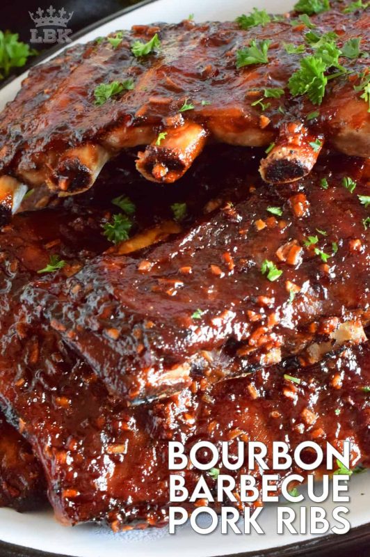 Bourbon Barbecue Pork Ribs are fall-off-the-bone tender. They are slow baked in the oven and basted with a thick and glossy, spicy and sweet, partially homemade bourbon barbecue sauce. Half a rack per person sounds right, yes!? #porkribs #bourbon #barbecue #oven #ribs