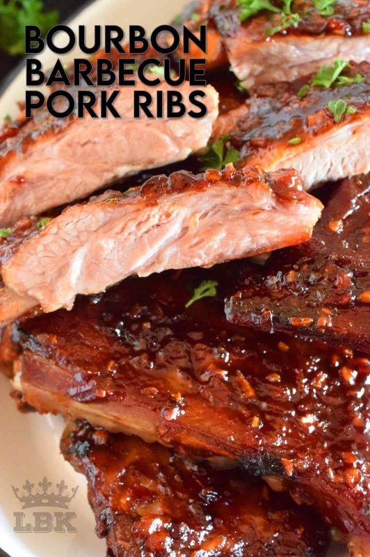 Bourbon Barbecue Pork Ribs are fall-off-the-bone tender. They are slow baked in the oven and basted with a thick and glossy, spicy and sweet, partially homemade bourbon barbecue sauce. Half a rack per person sounds right, yes!? #porkribs #bourbon #barbecue #oven #ribs