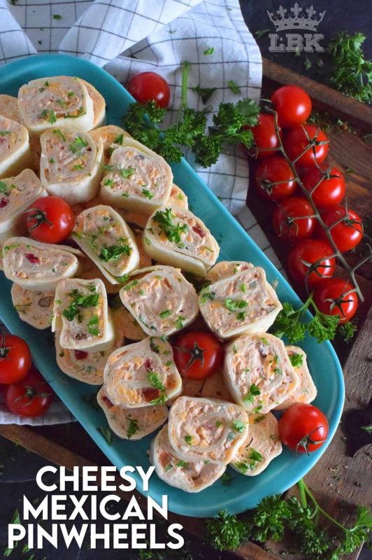 Is it a meal or is it an appetizer?  I guess that all depends on how many of these you eat!  Cheesy Mexican Pinwheels are easy to assemble, has lots of cheese, sour cream, and salsa too!  Make them mild or be bold and up the heat factor! #mexican #pinwheels #appetizers #partyfood #rollups