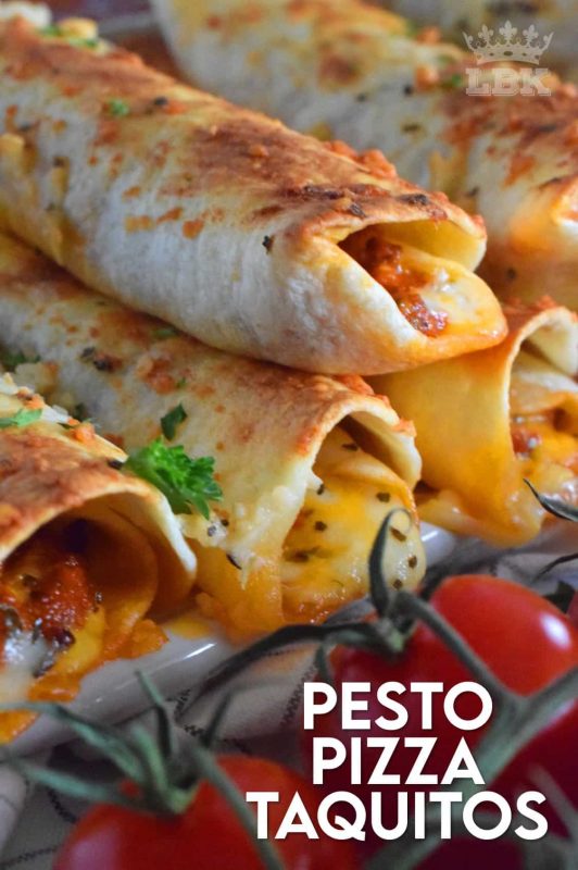 Prepared with homemade sun dried tomato pesto and lots of melted, gooey cheese, Pesto Pizza Taquitos are baked in the oven with a garlic and parmesan topping. Sounds irresistible, right? #taquitos #vegetarian #pesto #pizza #sundriedtomato