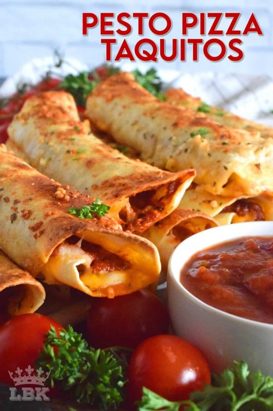 Prepared with homemade sun dried tomato pesto and lots of melted, gooey cheese, Pesto Pizza Taquitos are baked in the oven with a garlic and parmesan topping. Sounds irresistible, right? #taquitos #vegetarian #pesto #pizza #sundriedtomato