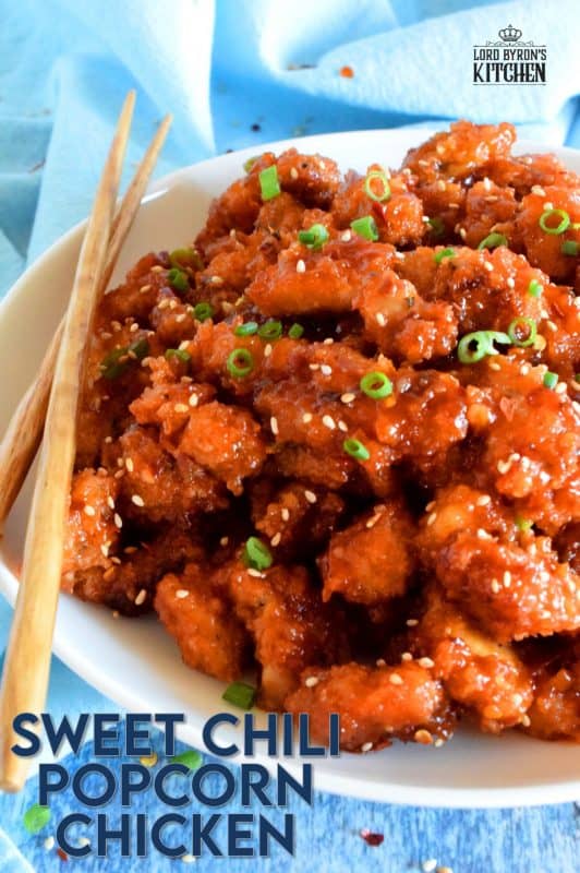 Marinated thigh meat, coated in panko and then baked until crispy, Sweet Chili Popcorn Chicken is then tossed in a homemade sauce which can be as mild or as hot as you prefer.  It's sticky, sweet, spicy, moist, and tender! #popcornchicken #sweetheat #sweetchilithai #thai #bakedchicken #spicy #sticky