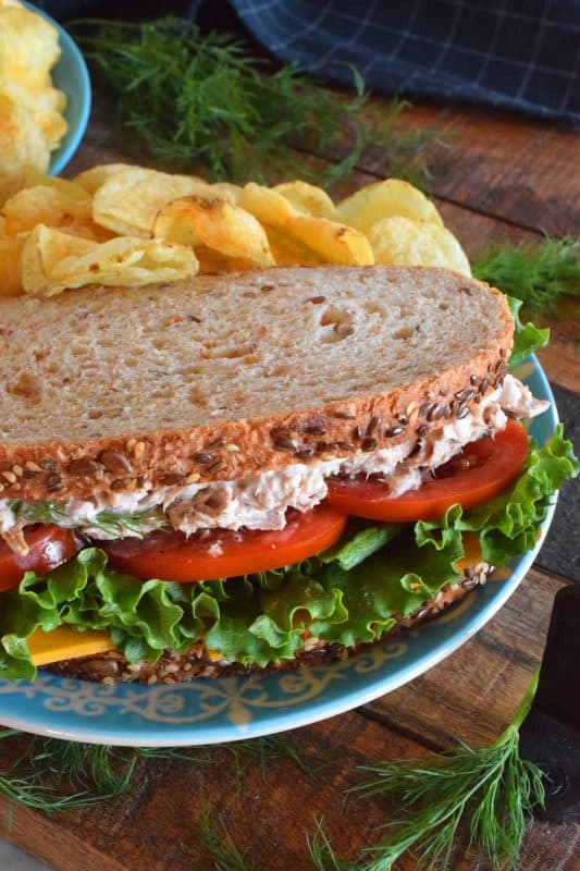 Who has time for boring sandwiches? You won't find that here, and this Dill Pickle Tuna Salad Sandwich is making sure of it! The tuna is prepared with dill pickles and fresh dill for maximum dill flavour. Finish it off with a slice of cheese, crisp lettuce, and sliced tomatoes all on great-tasting, multi-grain bread! #sandwich #dillpickle #dill #tuna #tunasandwich #tunasalad