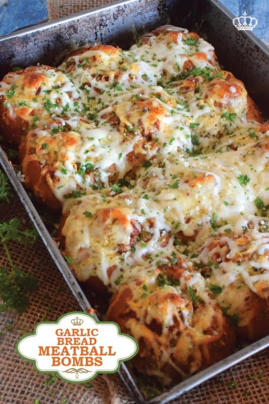 Garlic Bread Meatball Bombs are hollowed out dinner rolls which have been liberally smeared with homemade garlic butter. Each roll is stuffed with a meatball and sauce, then topped with cheese. Baked to a bubbling, gooey perfection, these bombs are the bomb! #meatballs #sliders #dinnerrollrecipes #bombs #meatballrecipes #familyrecipes #garlicbread