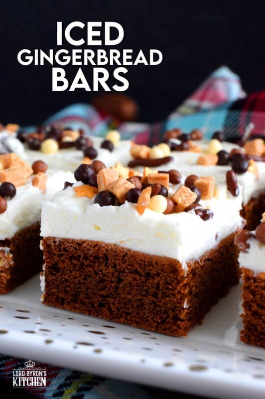 Soft, moist, and fudge-like; these Iced Gingerbread Bars taste like the familiar flavours of Christmas, but have the texture of a dense, chocolaty brownie. #christmas #holiday #baking #gingerbread #bars #squares #cookies