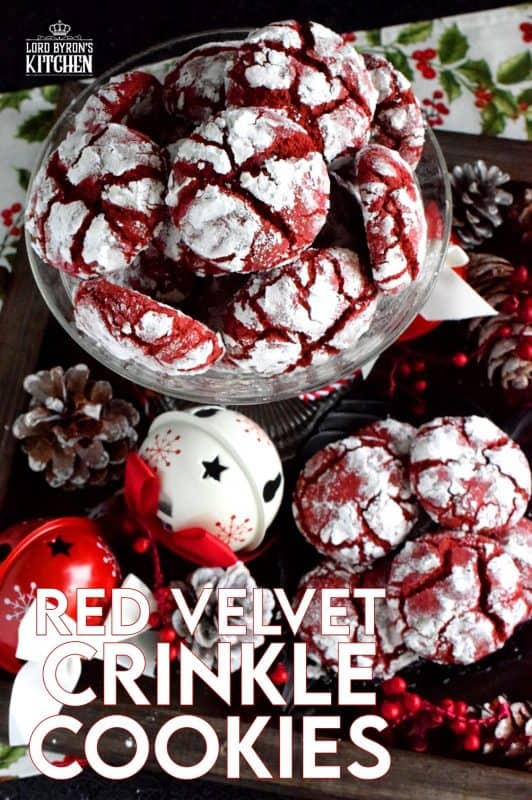 A delicious red cookie dough is rolled into powdered sugar to create these puffy, moist, Red Velvet Crinkle Cookies – the red and white lends itself well to holiday baking! #christmas #holiday #cookies #baking #red #velvet #redvelvet