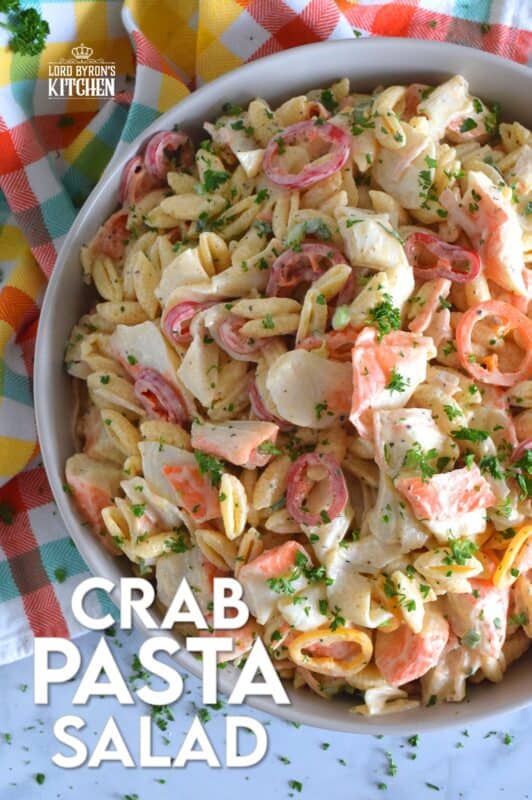 Flaked crab is paired with pasta and peppers in this Crab Pasta Salad. It is tossed in a creamy and tangy dressing made with mayonnaise, old bay seasoning, celery salt, and more. A great make-ahead salad best served slightly chilled with your favourite grilled beef! It's surf and turf - summer style! #crab #pasta #salad #imitation