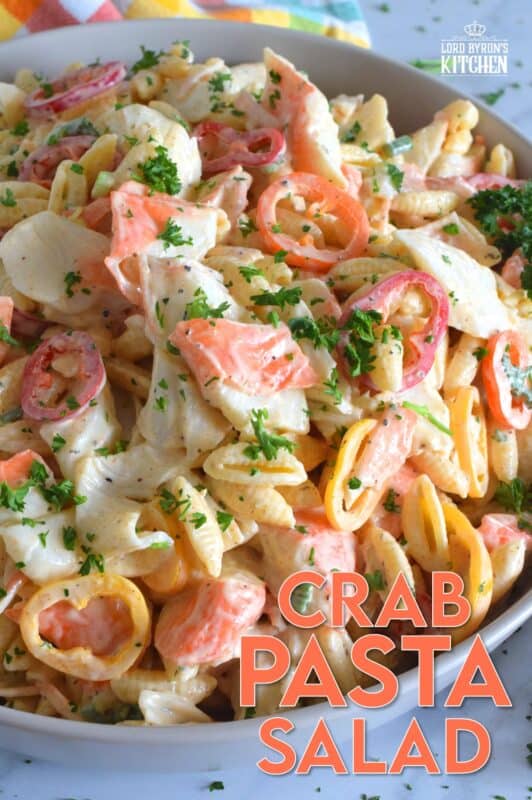Flaked crab is paired with pasta and peppers in this Crab Pasta Salad. It is tossed in a creamy and tangy dressing made with mayonnaise, old bay seasoning, celery salt, and more. A great make-ahead salad best served slightly chilled with your favourite grilled beef! It's surf and turf - summer style! #crab #pasta #salad #imitation