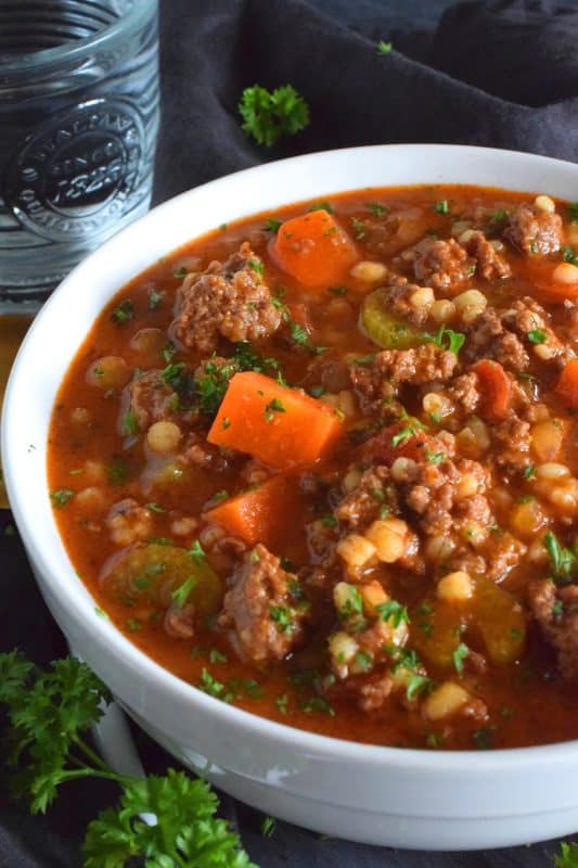 Traditionally, beef stew is made with chuck and can be pricey for the budget-conscious family. Using inexpensive ground beef is a great solution. It's readily available and affordable too. Paired with barley and a few vegetables, this stew is simply delicious! #beef #groundbeef #barley #stew #beefstew