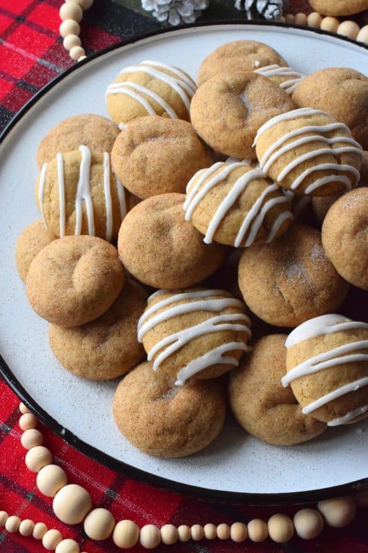 A soft, chewy cookie prepared with sour cream and familiar, warming, Christmastime spices. Spiced Sour Cream Cookies are loaded with cinnamon, cloves, ginger, and nutmeg too, which makes them a very comforting and cozy confection! The drizzled glaze is completely optional too! #christmas #holiday #baking #spiced #cookies #chewycookies