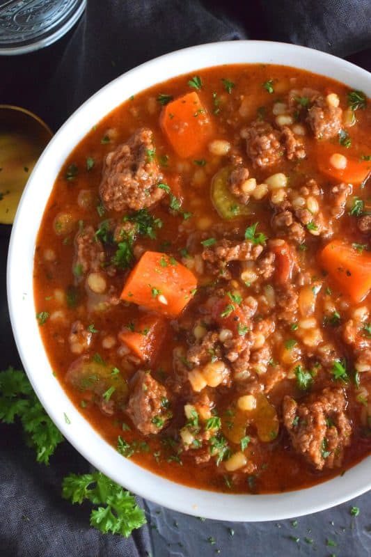 Traditionally, beef stew is made with chuck and can be pricey for the budget-conscious family. Using inexpensive ground beef is a great solution. It's readily available and affordable too. Paired with barley and a few vegetables, this stew is simply delicious! #beef #groundbeef #barley #stew #beefstew