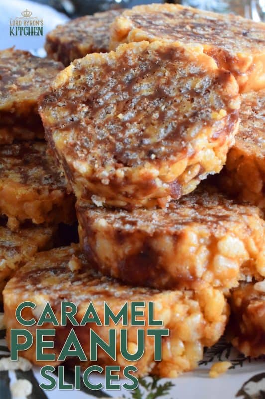 Caramel Peanut Slices are a no-bake confection consisting of caramel, peanut butter, rice krispies cereal, chocolate, and chopped peanuts. Working in layers, it is rolled into a log and chilled until set. The log is cut into slices before being served. These cookies are irresistible and one of my all-time favourite Christmas treats! #caramel #caramellogs #christmas #holiday #nobake #cookies #peanutbutter