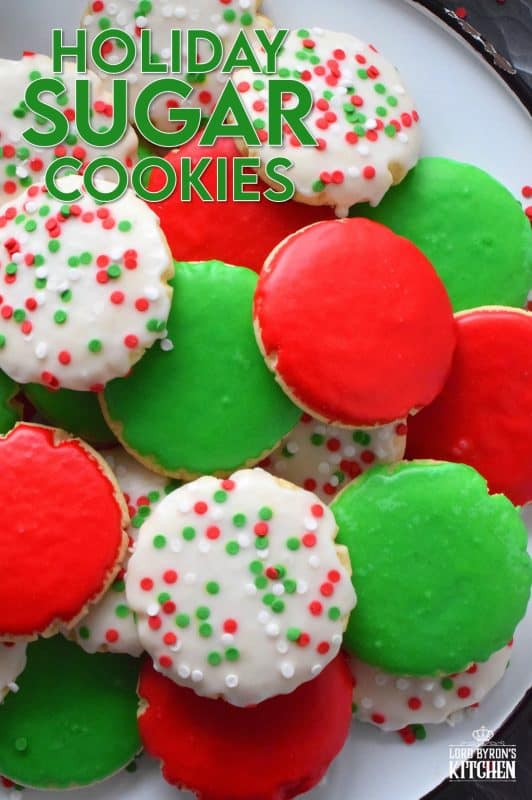 This recipe consists of a melt-in-your-mouth sugar cookie base, topped with a thin, sugary glaze, and festive sprinkles. Holiday Sugar Cookies are brightly and vividly coloured with red and green frosting and will appeal to both the little kids and the big kids in your life! #christmas #holiday #baking #sugarcookies #cookies