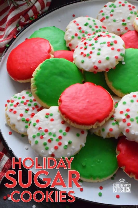 This recipe consists of a melt-in-your-mouth sugar cookie base, topped with a thin, sugary glaze, and festive sprinkles. Holiday Sugar Cookies are brightly and vividly coloured with red and green frosting and will appeal to both the little kids and the big kids in your life! #christmas #holiday #baking #sugarcookies #cookies