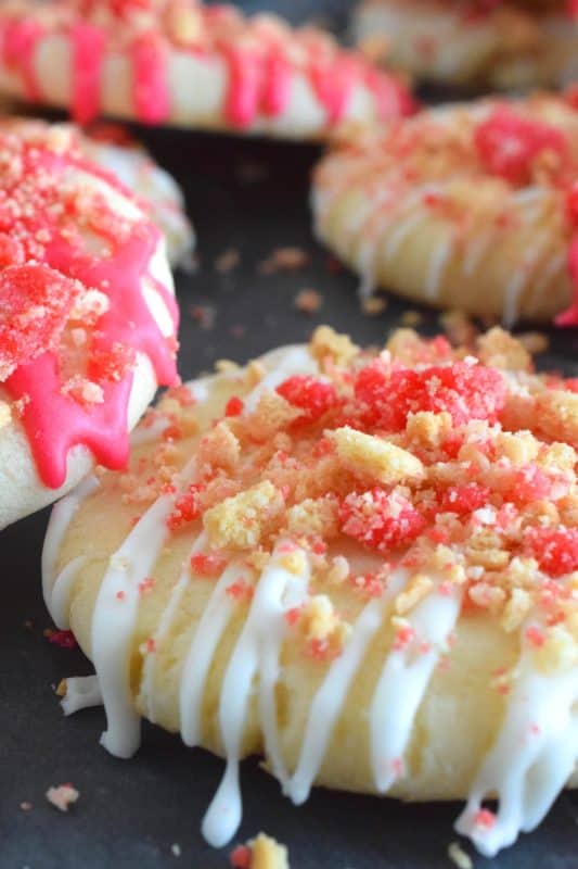 The uncomplicated and delicious sugar cookie gets a fresh, new flavour profile, and an upgrade in this Strawberry Shortcake Sugar Cookies recipe. A classic sugar cookie base is topped with a simple glaze and sprinkled with homemade shortcake crumbs. These would make a great giftable dessert idea for Valentine's Day! #sugarcookies #cookies #valentines #strawberry #shortcake