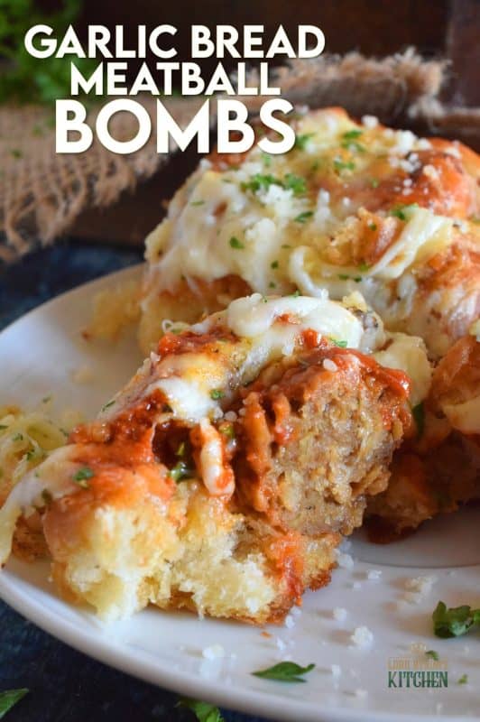 Garlic Bread Meatball Bombs are hollowed out dinner rolls which have been liberally smeared with homemade garlic butter. Each roll is stuffed with a meatball and sauce, then topped with cheese. Baked to a bubbling, gooey perfection, these bombs are the bomb! #meatballs #sliders #dinnerrollrecipes #bombs #meatballrecipes #familyrecipes #garlicbread