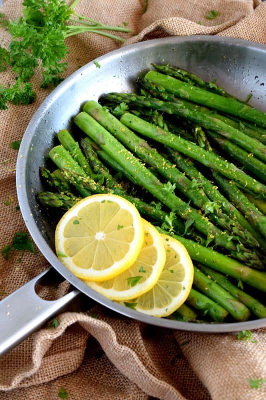 Lemon Butter Asparagus is as simple as it gets - gently sautéed asparagus in a little salted butter with lemon juice, lemon zest, and seasoning.  It's a side that is bright and refreshing; a perfect spring and summer side! #asparagus #fresh #saute #skillet #lemon #butter #fried