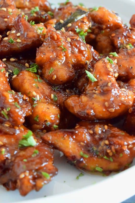 Fried Garlic Chicken is a crispy fried chicken in a thick and savoury garlic sauce; this dish is most certainly for the garlic lover. Prepared with a unique battering technique, and double fried, this chicken is sweet and super garlicky - it's made with twelve cloves of garlic! #garliclovers #garlicky #friedchicken #chicken #thighs