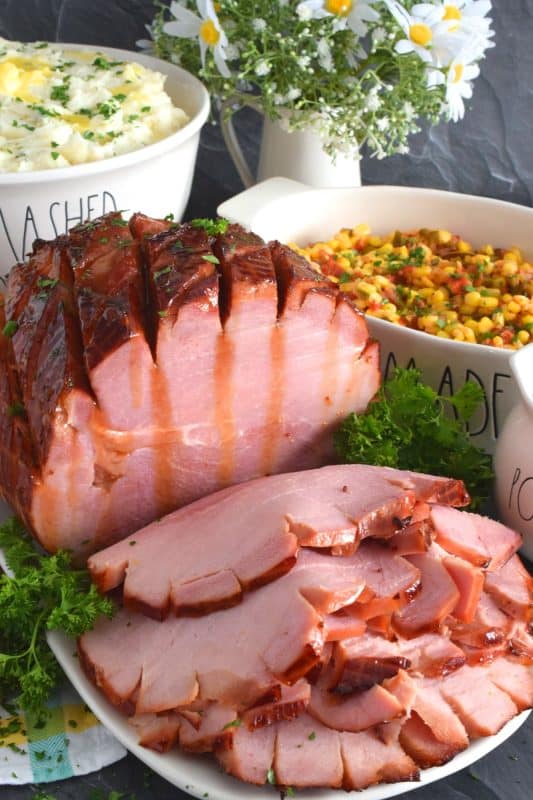 Take all of the guesswork out of preparing a large ham with this recipe! Brown Sugar Mustard Glazed Virginia Ham is easy to prepare and it looks incredible! This ham is perfectly baked, it is moist and tender, and has a sweet and sticky glaze with just a little bite to it - you will hope for leftovers, because this ham is too good to not have some the next day! #virginiaham #countryham #ham #glazedham #bakedham