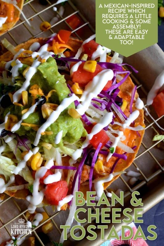 Bean and Cheese Tostadas are piled high with fresh veggies and topped with guacamole and sour cream. They're like an unrolled burrito with the crunch of a taco. Try eating just one! #tostadas #Mexican #recipes #vegetarian