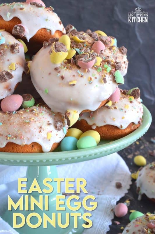 When it comes to donuts, chocolate is always a great choice. Easter Mini Egg Donuts are prepared with a vanilla batter, loaded with crushed Cadbury mini eggs, topped with a simple sugar glaze, and more crushed mini eggs! Easter treats never tasted so good! #donuts #bakeddonuts #doughnuts #easter #cadbury #minieggs