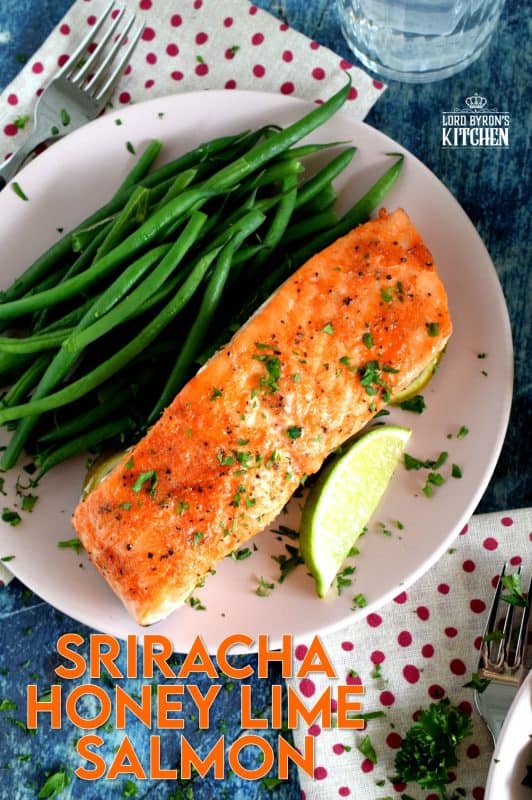 Slightly sweet with a little tartness, Sriracha Honey Lime Salmon is oven baked on a bed of sliced limes for extra zing and fresh flavour. The sriracha and honey combine to make a wonderful basting sauce with the perfect balance of sweet and heat. #sriracha #honey #honeylime #salmon #bakedsalmon #spicysalmon