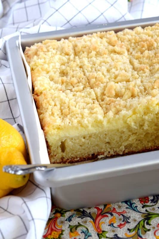 Lemon Cream Cheese Coffee Cake is extra lemony, with a creamy filling and a crumbly topping.  Light, refreshing, and delicious; brew the coffee and invite your friends! That's assuming you'll want to share this cake with anyone after you get your first taste! #lemon #coffee #cake #cream #cheese #dessert #summer