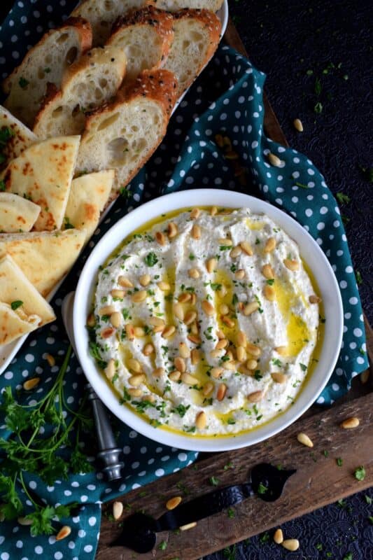 Salty and velvety smooth, seasoned with pantry herbs and spices, Creamy Whipped Feta will satisfy all of your snack cravings. Smear it on crackers and bread, or use it as a dip with veggies or pita.  For even more flavour, be sure to toast the pine nuts first! #feta #fetadip #whippedfeta #dip #spread #appetizer