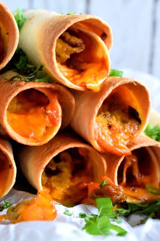 Great for guests or a quiet Saturday morning breakfast with your family. All of the prep can be done ahead of time too! These sausage and egg filled taquitos are perfectly crispy and cheesy! Use ground sausage meat or a whole sausage! #breakfast #taquitos #breakfastsausage #brunch