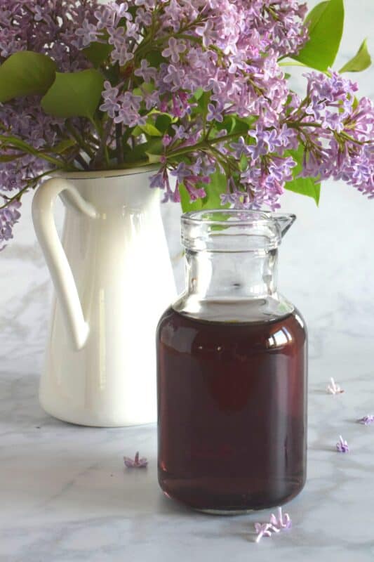 Lilacs are in full bloom right now, and if you're lucky enough to have a few trees near your house, I'm sure you can smell that lovely fragrance. Did you know that lilac petals are edible? Lilac Syrup is made with fully-bloomed lilac petals and is a great way to infuse some of your favourite early summer recipes with the lovely scent and a slightly citrus-like taste. #lilac #simplesyrup #cookingwithlilacs #lilacs #edibleflowers