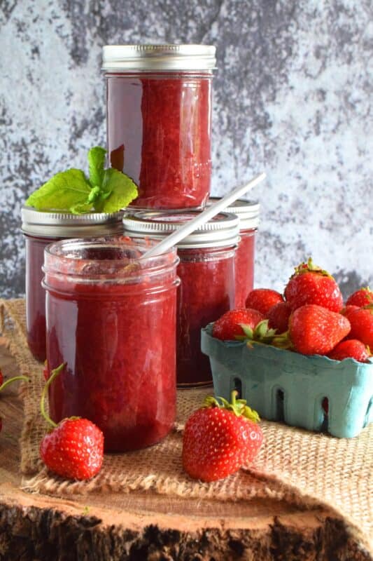In early summer, when strawberries are in season, is the time to stock your pantry with homemade Canned Strawberry Jam. This post will walk you through the steps to ensure you have safe and fresh-tasting jam all year long. If you've never made your own jam, you're in for a real treat! #strawberryjam #strawberries #canning #jam #preserves #cannedjam #waterbath