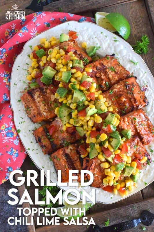 Salmon fillets are marinated in olive oil with honey, lime juice, seasonings, and spices then grilled until charred, yet still light and flaky on the inside. Topped with a salsa consisting of avocado, corn, tomatoes, and lime, this grilled salmon is not only refreshing and delicious, but also quite a beautiful and impressive main for you and your family this summer! #salmon #grillesalmon #chililime #salsa #summermeals #grilled #seafood
