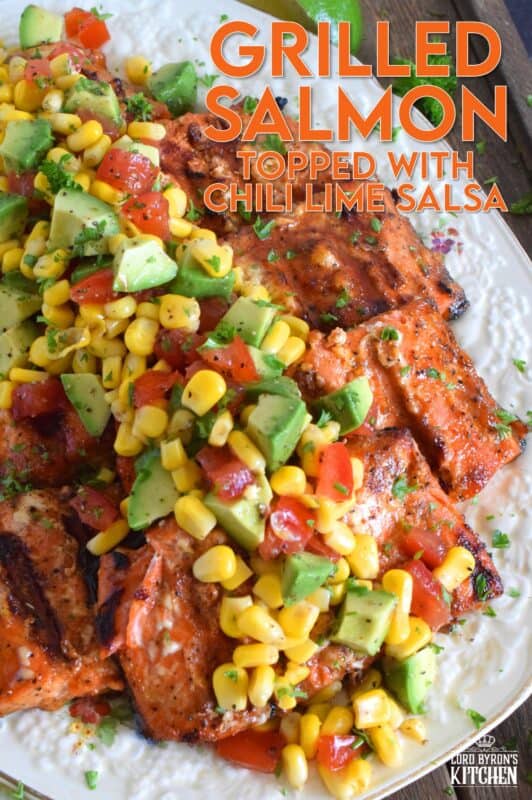 Salmon fillets are marinated in olive oil with honey, lime juice, seasonings, and spices then grilled until charred, yet still light and flaky on the inside. Topped with a salsa consisting of avocado, corn, tomatoes, and lime, this grilled salmon is not only refreshing and delicious, but also quite a beautiful and impressive main for you and your family this summer! #salmon #grillesalmon #chililime #salsa #summermeals #grilled #seafood