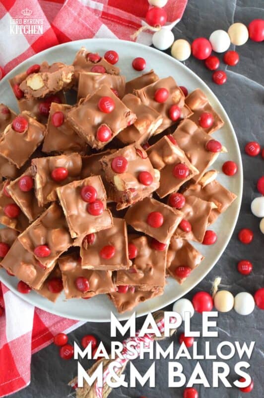 Prepared with chocolate, maple flavoured marshmallows, candy, and more, Maple Marshmallow M&M Bars are a cross between homemade fudge and a store-bought candy bar. Whip up a batch and keep them in your freezer. They are super delicious when eaten frozen on a cold, summer day! #marshmallow #maple #nobake #canadaday #fudge #redandwhite #candy