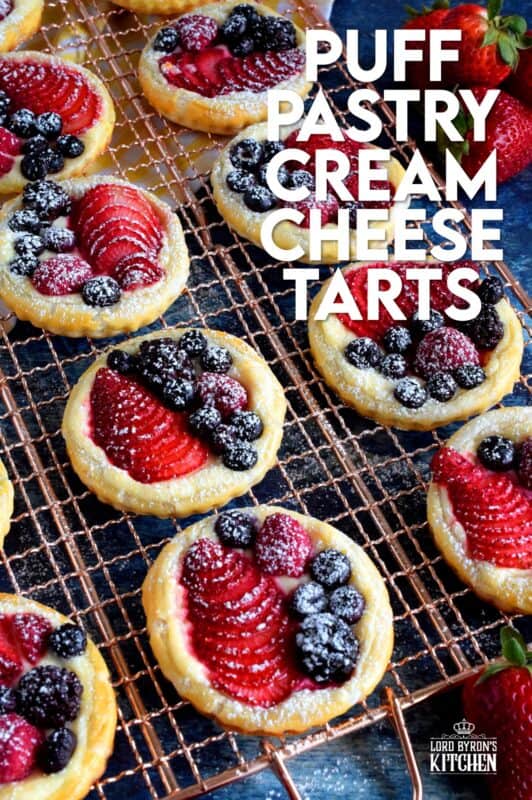 Transform store-bought, frozen sheets of puff pastry into these delightful little tarts filled with fresh berries and a lemony cream cheese filling! Use your favourite berries or fruit and then try to eat just one - it's nearly an impossible feat! #puffpastry #berries #4thofjuly #recipes #summer #creamcheese #tarts #tartlets #fruit