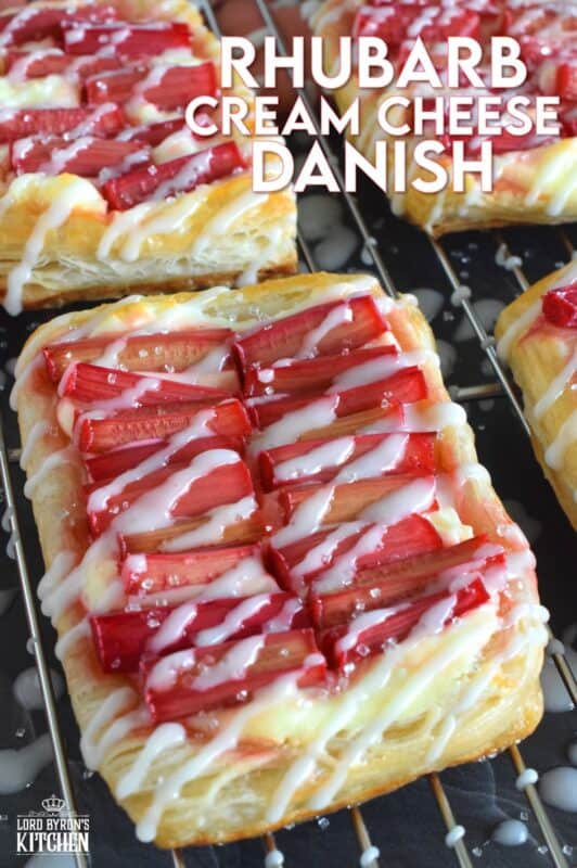 Puff pastry is rolled out and cut to form the base for these Rhubarb Cream Cheese Danish delights! Spread with a sweet, cream cheese mixture and topped with fresh rhubarb, they're baked until golden brown, crispy and flaky. Once cooled, they are drizzled with an easy to prepare glaze. It's so hard to eat just one of these! #creamcheese #rhubarb #danish #tart #puffpastry