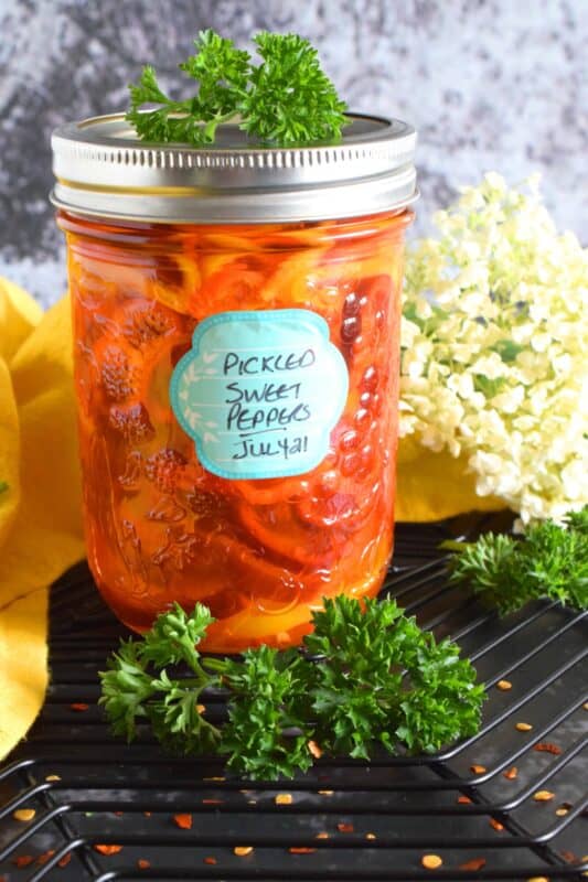 Pickled Sweet Peppers are tart, sweet, and just a little spicy. These are so easy to make and there's no canning experience needed at all! If you can boil water and slice sweet peppers into rings, you've got this! #pickled #pickles #peppers #sweetpeppers #pickledpeppers #preserving #quickpickles