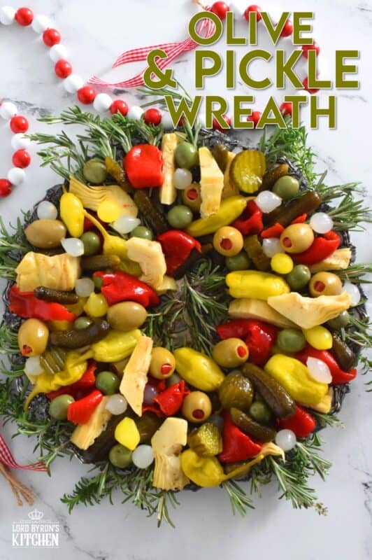 This bright and shiny edible wreath is packed full of sweet, salty, and tangy flavour! Consisting of your favourite pickled and marinated foods, an Olive and Pickle Wreath is the answer to every host's holiday appetizer table. Assemble on a platter and refrigerate until ready to serve. It's easy, delicious, and festive! #olives #pickles #charcuterie #christmas #holiday #partyfood