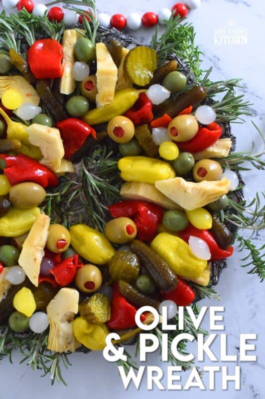 This bright and shiny edible wreath is packed full of sweet, salty, and tangy flavour! Consisting of your favourite pickled and marinated foods, an Olive and Pickle Wreath is the answer to every host's holiday appetizer table. Assemble on a platter and refrigerate until ready to serve. It's easy, delicious, and festive! #olives #pickles #charcuterie #christmas #holiday #partyfood