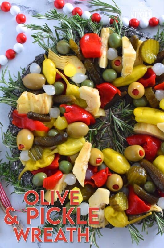 This bright and shiny edible wreath is packed full of sweet, salty, and tangy flavour! Consisting of your favourite pickled and marinated foods, an Olive and Pickle Wreath is the answer to every host's holiday appetizer table. Assemble on a platter and refrigerate until ready to serve. It's easy, delicious, and festive! #olives #pickles #charcuterie #christmas #holiday #partyfood