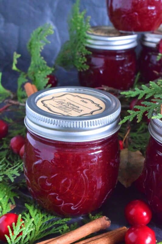 Cinnamon, ginger, allspice, and cloves come together to create a warm and cozy holiday flavour in this Spiced Christmas Jam recipe.  Made with strawberries and cranberries, this jam is both sweet and tart with a warming and comforting hint of seasonal spice. #spiced #jam #cloves #christmas #cinnamon